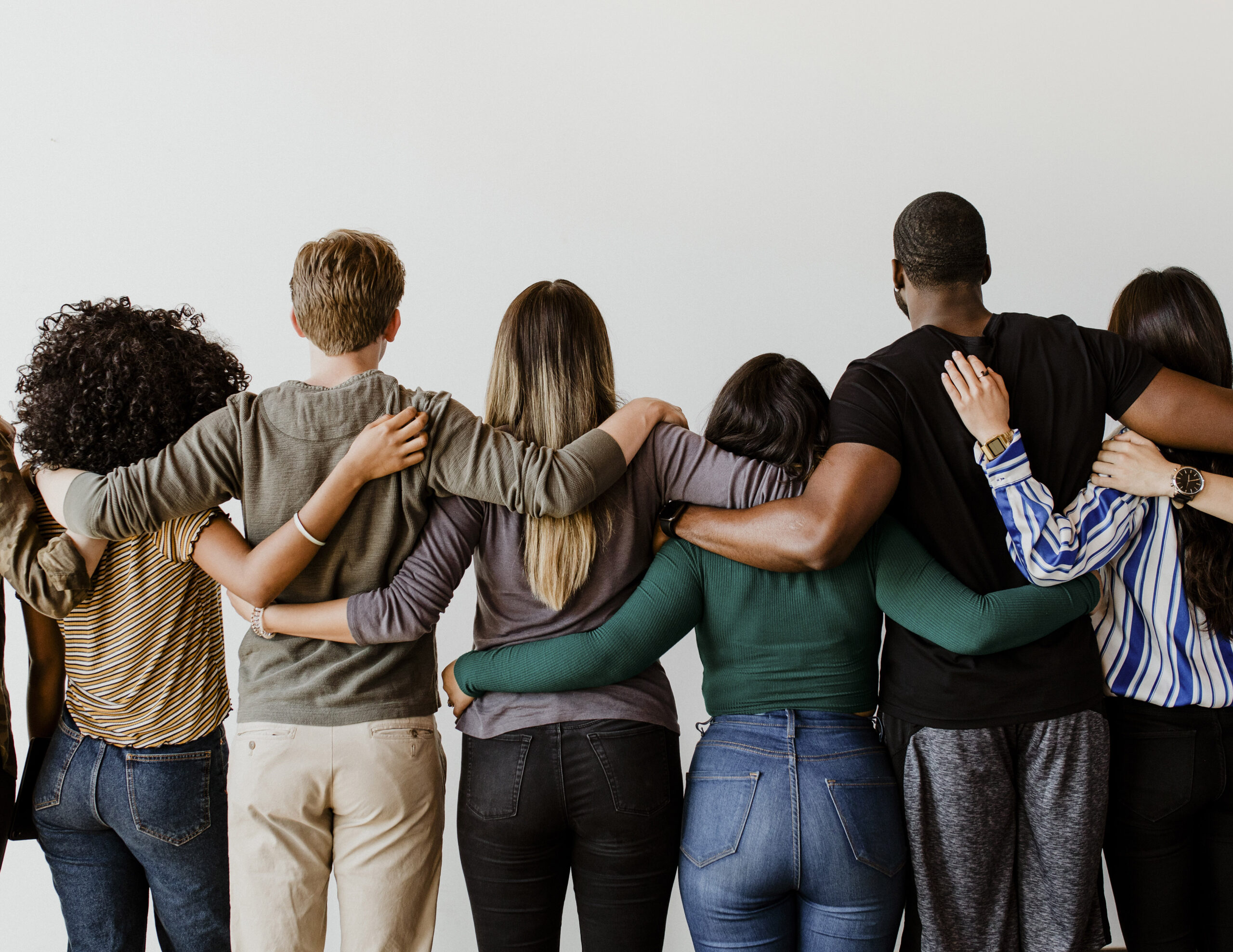Rearview of diverse people hugging each other